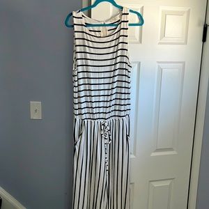 This outfit is a 1x never worn black & white jumpsuit with pockets wide leg